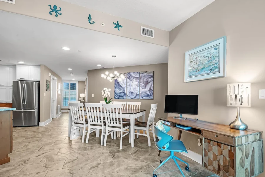 Dining area with a table, kitchen and television