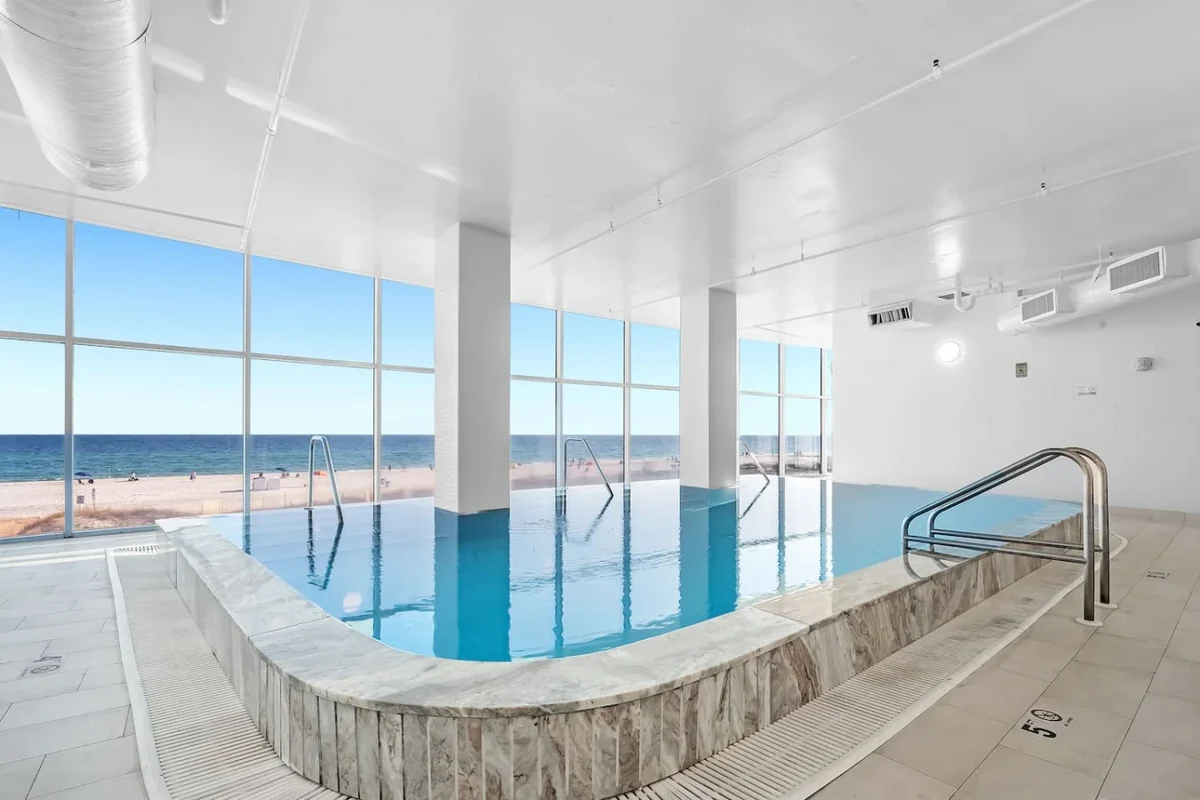 Gulf Shores indoor pool with ocean and beach views through the windows